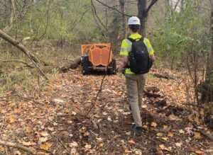 Luke Scherpenisse works with the company’s Green Climber remote-controlled forestry mower.