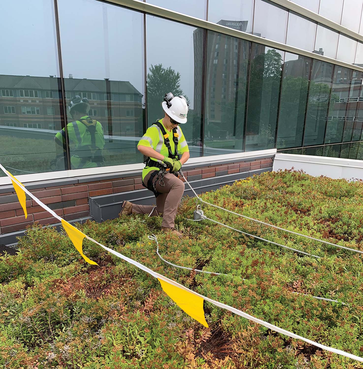 Photo 4: A worker getting ready to switch from their personal fall-arrest system into fall restraint. non-traditional job site. 