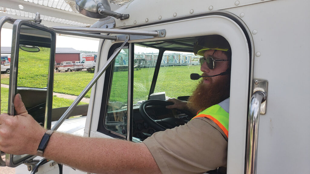 Use a spotter when backing up to reduce property damage and prevent crew injuries. Every year a tree-company truck backs over a worker fueling a chain saw. Photo is of Cody Thompson, courtesy of Glacial Lakes Tree Service.